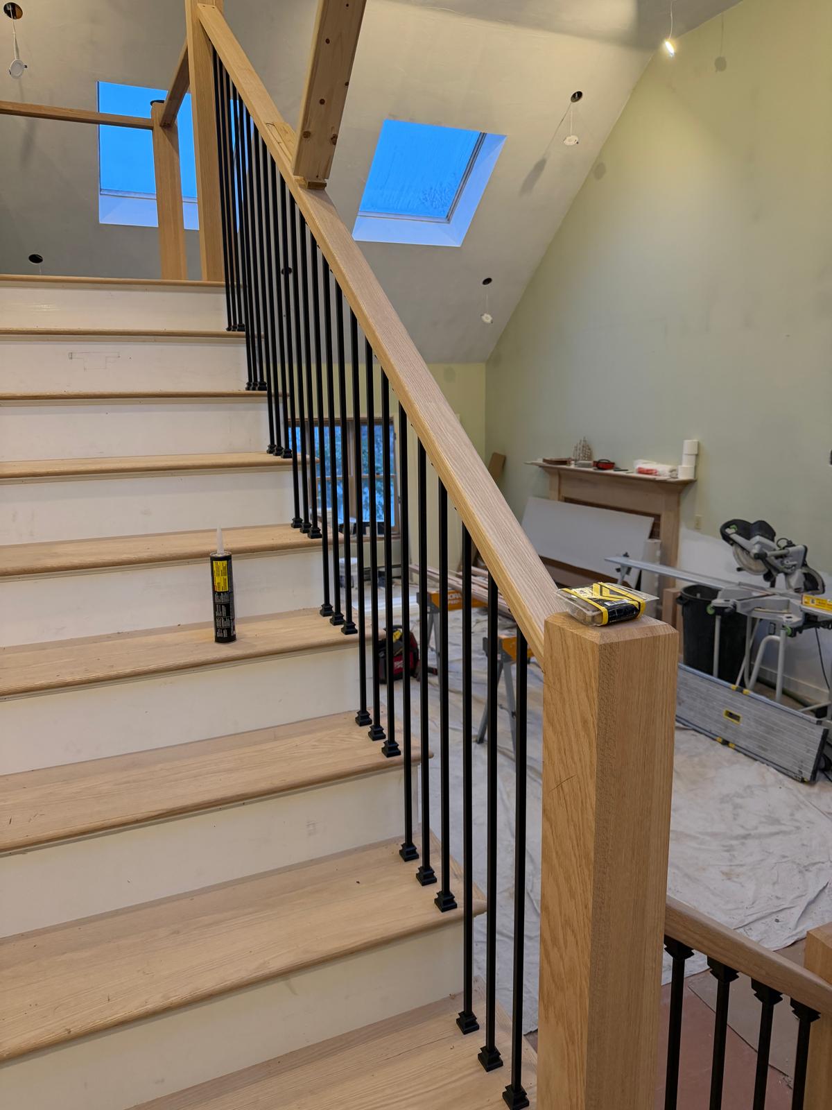Oak staircase with iron balusters under skylights